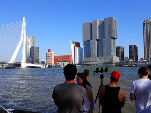 Fixer Rotterdam crew on location at the Erasmus Bridge with the city skyline in the background